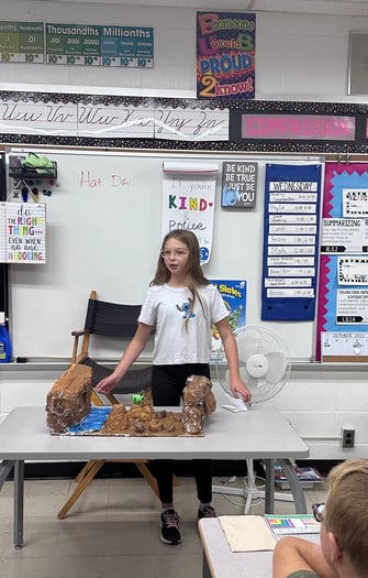 5th grade girl displaying 3D geography model