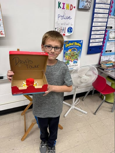 5th grade boy showing Devils Tower model
