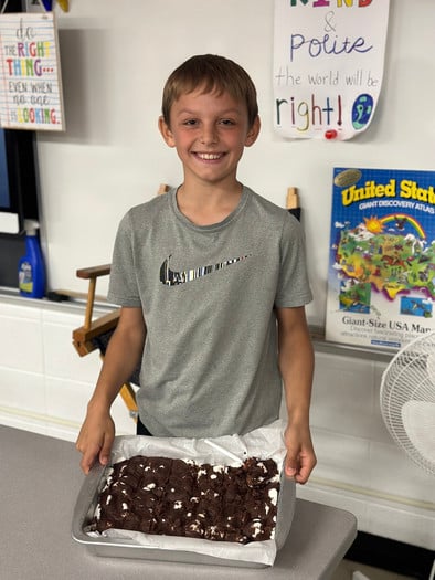 5th grade boy showing baked goods